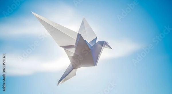 Obraz A white paper crane flies against a bright blue sky.