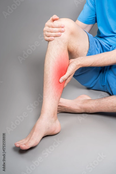 Obraz Calf muscle cramped, massage of male leg