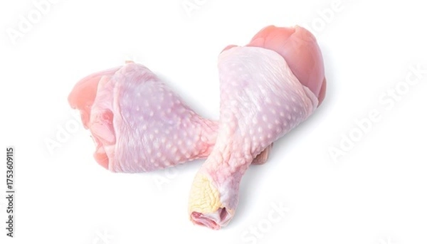 Obraz A studio shot features two raw chicken drumsticks, pale pink with visible skin textures, against a clean, white background. The lighting is soft and even