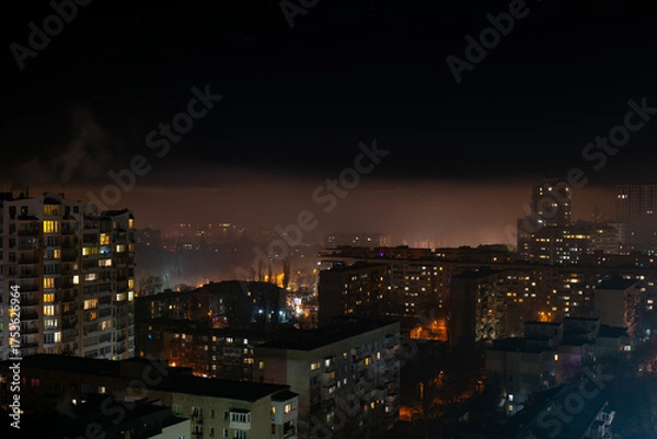 Fototapeta Night cityscape with glowing residential buildings beneath a surreal fog layer. Above the mist, a modern skyline emerges, creating a dramatic contrast and dreamlike atmosphere.