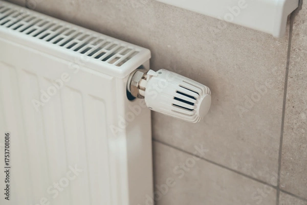 Obraz White heating radiator with thermostatic temperature regulator. Heating season. Energy saving