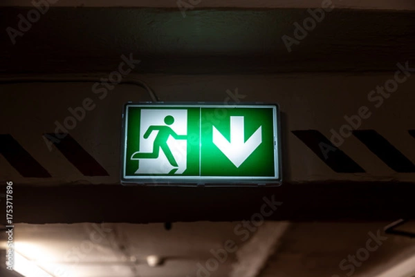 Fototapeta Emergency exit green light sign. 