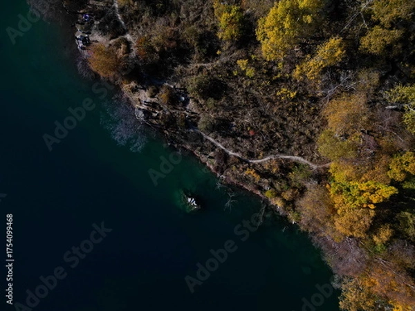 Fototapeta Lake Issyk in the rays of the setting sun. National Nature Park. Mountainous area with different vegetation.