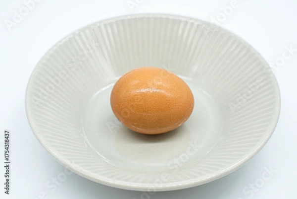 Obraz Boiled eggs in a circular bowl on a white background