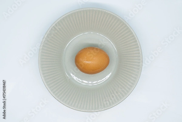 Obraz Boiled eggs in a circular bowl on a white background