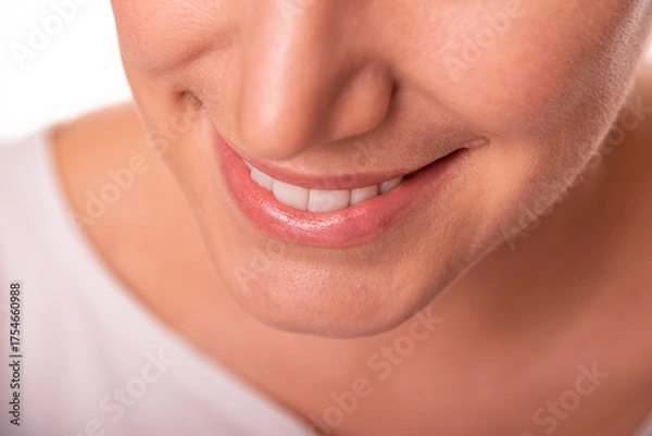 Obraz Close-up image of a smiling woman showing her white teeth and natural lips, representing happiness, confidence, and dental health.