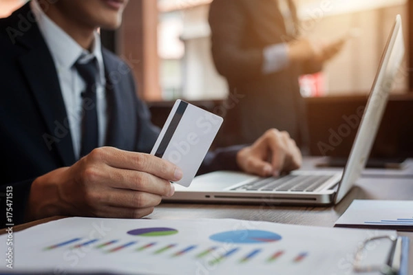 Fototapeta businessman holding credit card and using laptop computer. Online shopping concept