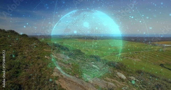 Fototapeta Displaying digital holographic globe floating above hillside, near rocky footpath toward farm plots
