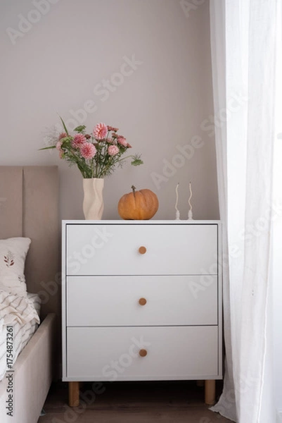 Obraz Transform your bedroom into a stylish space with a bouquet, decorative pumpkin, and chic, comfortable furniture.