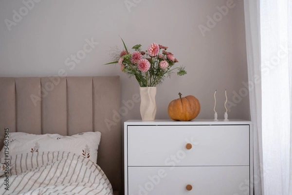 Obraz Transform your bedroom into a stylish space with a bouquet, decorative pumpkin, and chic, comfortable furniture.