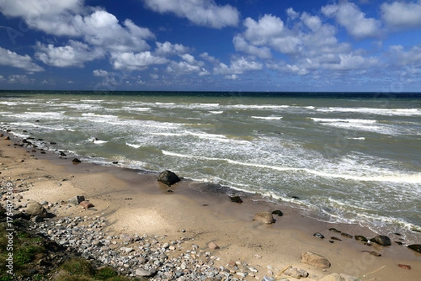 Fototapeta Landscape photo with a view of the North Sea coast against a blue sky with clouds near Hirtshals fyr Lighthouse in Denmark