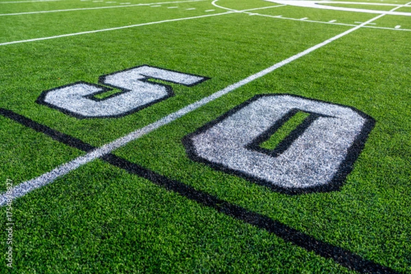 Obraz Green synthetic turf football 50 yard line, block number, in white along with black lacrosse line.	