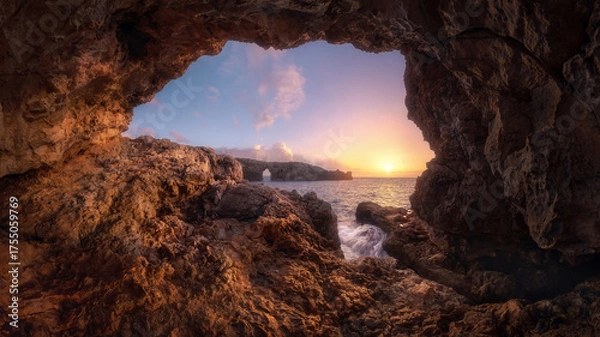 Obraz Sunset View from a Sea Cave Overlooking Natural Rock Arch in Menorca