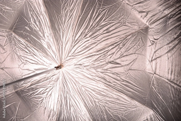 Fototapeta Silver reflective material in studio umbrella reflecting light from strobe.