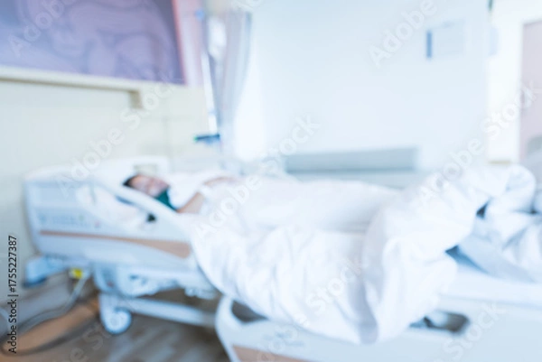 Obraz Blur image of patient on bed and nurse working area in internal medicine departments at the hospital.Medical treatment emergency patient.Caregiver and hopeful concept.