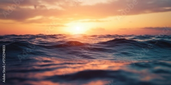 Obraz A serene sunset over the ocean with gentle waves and a vibrant sky.