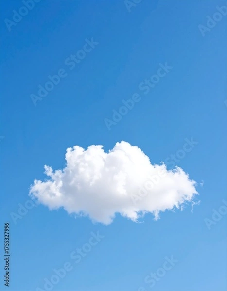Obraz A fluffy white cloud drifts lazily across a bright blue sky, illuminated by the warm sunlight, creating a serene and tranquil atmosphere.
