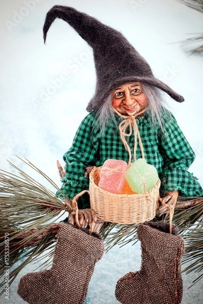 Fototapeta Whimsical Witch Doll with Candy, on a Pine Branch.