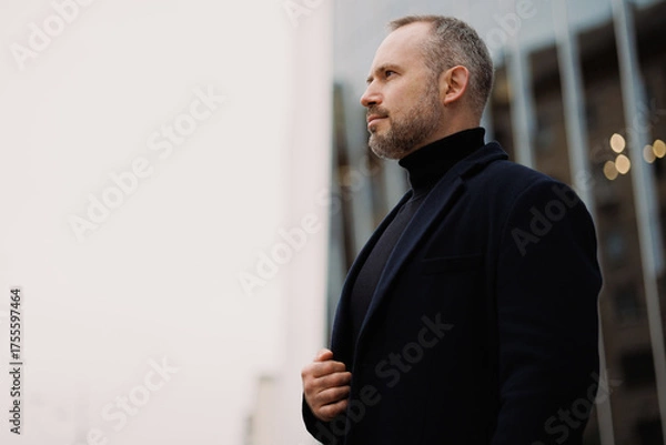 Obraz Confident man in elegant coat standing on city street