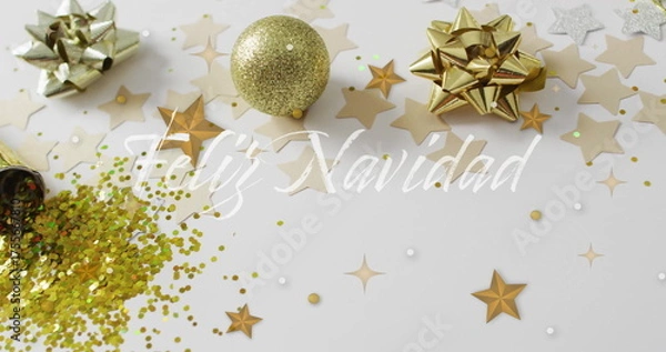 Fototapeta Feliz Navidad text image over Christmas decorations with stars and glitter