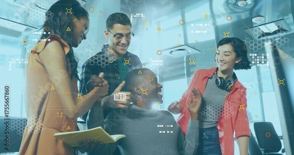 Obraz Collaborating tech team brainstorming with seated colleague in office using notebook and pen