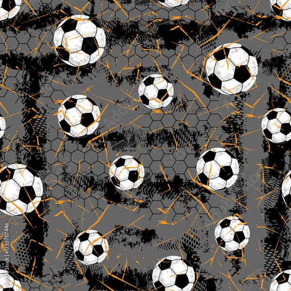 Obraz Modern football texture with black and white soccer balls on gray background and orange splashes. Ideal for streetwear, sports branding, posters, and athletic textile design.