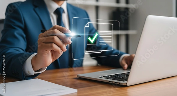 Fototapeta Businessman reviewing document on a screen with a green check mark using a laptop at his desk, showing compliance, approval, and quality control