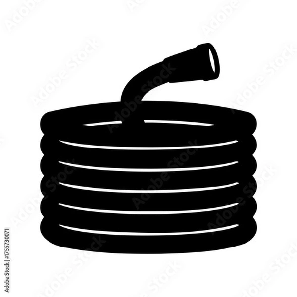 Fototapeta Coiled garden hose ready for watering the plants in the garden