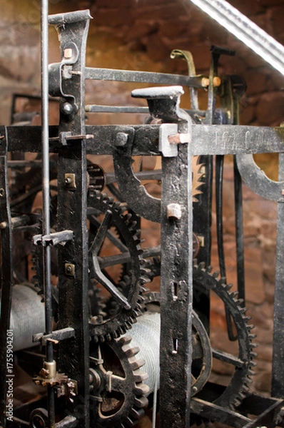 Fototapeta Antique church clock mechanism with metal gears. Perfect for illustrating vintage machinery, time concepts, history, or industrial design.