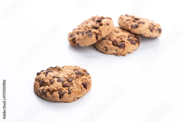 Fototapeta Chocolate chip cookie on a white background. In the background, a group of blurred cookies.