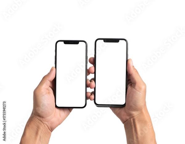 Fototapeta Human hands hold up two adjacent smartphones with blank screens, set against a black background