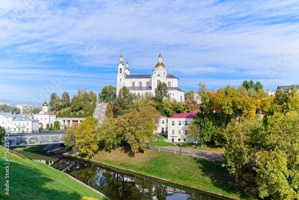 Fototapeta Vitebsk, Belarus, October 8, 2025. Autumn view of the temple complex by the river.                               