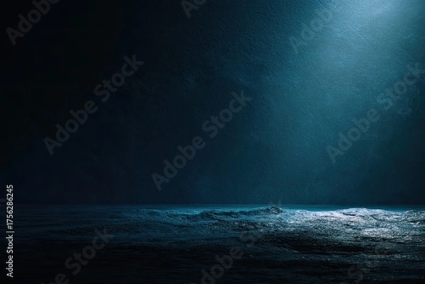 Fototapeta Dramatic dark blue ocean scene with waves illuminated by a single light source