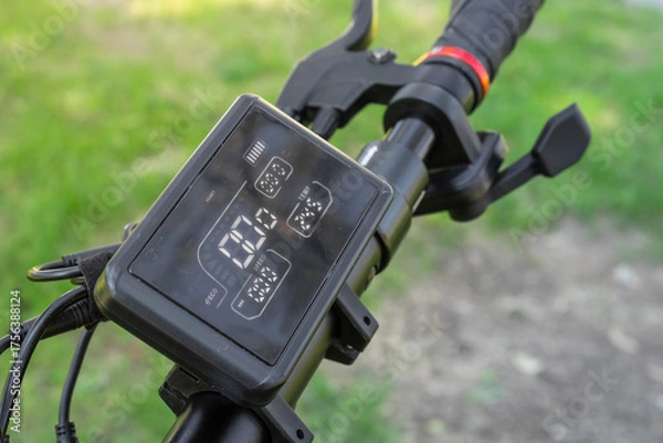 Fototapeta Electric scooter handlebar with digital display and brake lever close-up