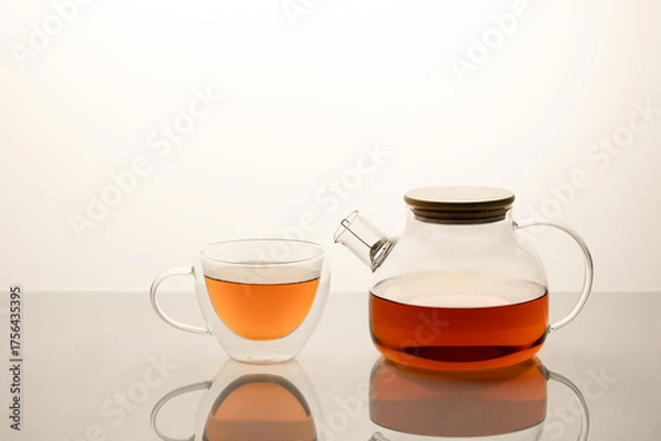 Fototapeta Glass Teapot and caps with black tea isolated on white background with reflection 
