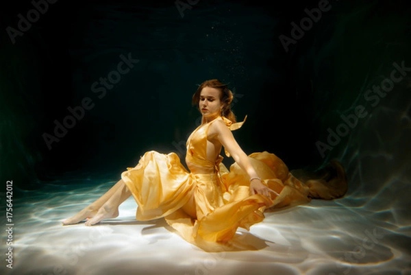 Obraz An Ethereal Underwater Dance Taking Place in a Beautiful Yellow Gown and Flowing Elegantly