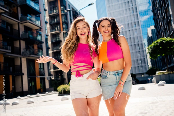 Fototapeta Fun sunny city duo embrace bright fashion vibes two stylish friends explore urban streets with smiles and energy on a sunny day in a modern traveler lifestyle moment