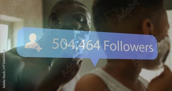 Fototapeta Grinning father and son shaving with cream at bathroom mirror, using razors under followers overlay