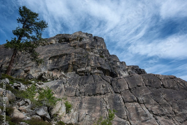 Fototapeta Granite cliffs at Donner Summit, California, USA, viewed under a vivid blue sky streaked with wispy clouds.