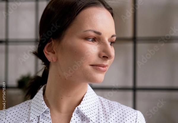 Obraz Portrait of a young woman in an office. Business and people concept.