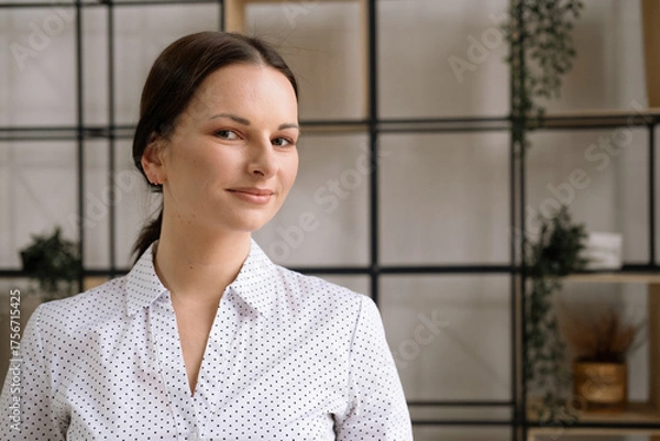 Obraz Portrait of a young woman in an office. Business and people concept.