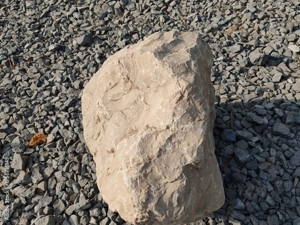 Obraz Large gray stones or rocks placed on crushed gravel, set within interlocking pathway.
Mountain-style rocks are laid throughout the garden or landscaped area, adding a natural and rugged aesthetic.