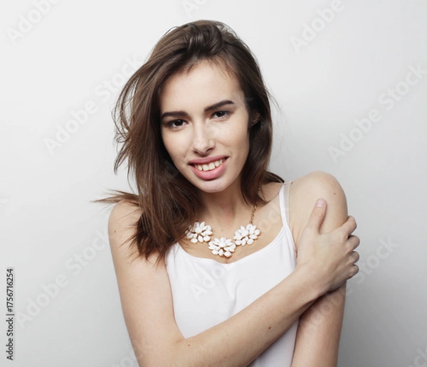Obraz beautiful young woman wearing casual clothes, posing on light grey background.