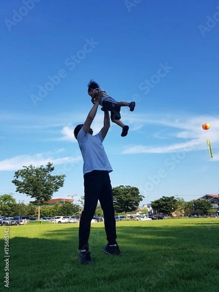 Obraz 아빠가 하늘 높이 던져올린 아기