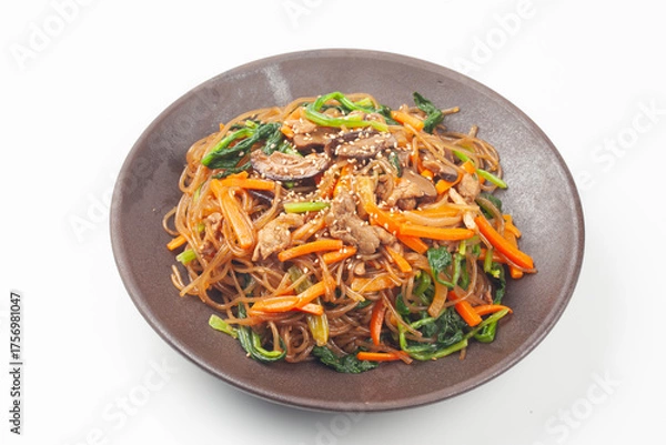 Fototapeta Japchae is a dish made by stir-frying vegetables, mushrooms, meat, and other ingredients and mixing them with boiled glass noodles.
