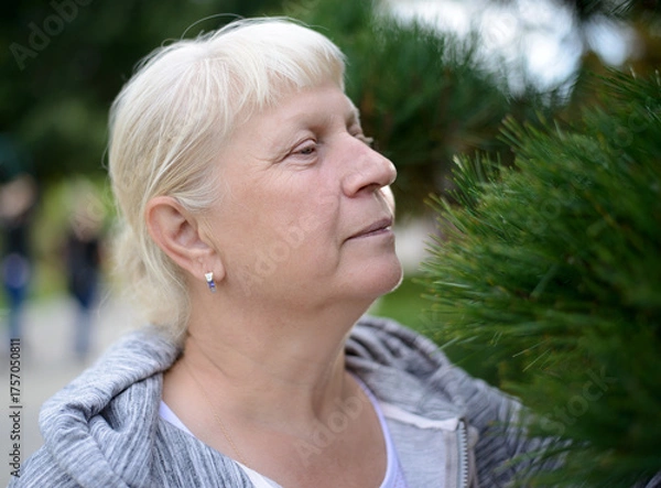 Obraz Aged woman exploring nature among greenery.