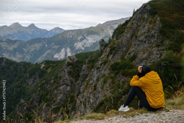Obraz Contemplative Moment on Mountain Cliff