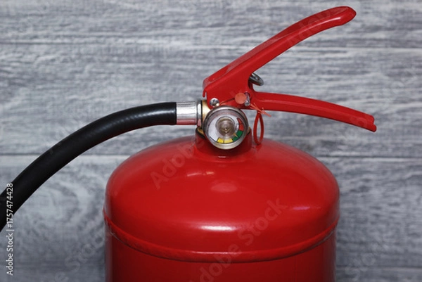 Fototapeta The red powder extinguisher with manometer. Closeup view.