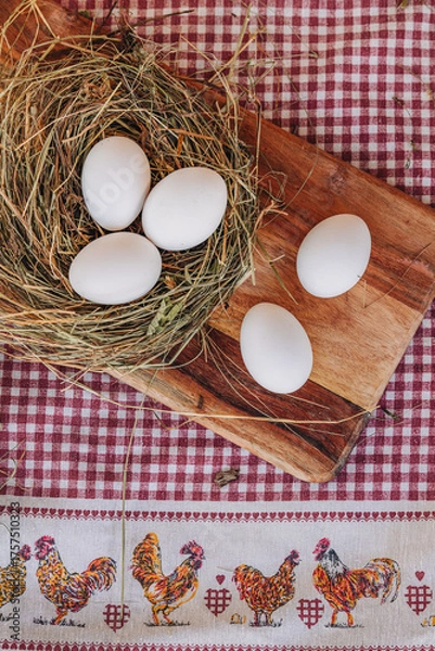 Fototapeta Fresh white eggs on a natural nest