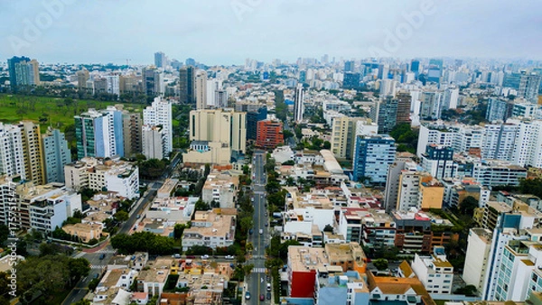 Fototapeta The vast San Isidro district in Lima seen by drone on a cloudy day.